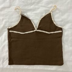 Brand New With Tags. One Size. Fits Xsmall-Small. Brown Color With Cream Lace Straps Perfect For Cowgirl Theme. Perfect Color For Fall Cute Beige V-neck Top, Brown Cami Top For Spring, Casual V-neck Crop Top With Lace Trim, Summer Brown Cami Top, Brown Cotton Tank Top For Day Out, Chic Brown Cotton Tank Top, Cute Brown Sleeveless Top, Beige Cotton Cami Crop Top, Brown V-neck Summer Top