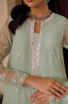 2 Piece Embroidered Suit for Women (SHIRT & DUPATTA) FABRIC: ORGANZA COLOR: GREEN WORK DETAILS: EMBROIDERED Description SHIRT: Style a-line Fabric organza Front embroidered, back plain dyed Neckline embroidered Sleeves embroidered DUPATTA: Organza sequin embroidered dupatta Formal Green Set With Mirror Work, Elegant Green Kurta With Mirror Work, Green Chikankari Embroidery Top For Wedding, Green Chikankari Embroidered Top For Wedding, Eid Long Sleeve Sets With Embroidered Neckline, Elegant Embroidered Pista Green Blouse, Eid Sets With Embroidered Neckline And Long Sleeves, Long Sleeve Sets With Embroidered Neckline For Eid, Green Blouse With Resham Embroidery For Eid