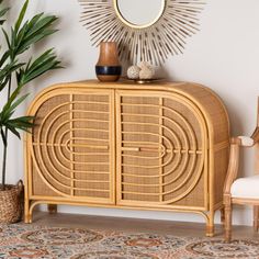 a wicker cabinet with a mirror on top next to a chair and potted plant