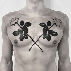 a man with tattoos on his chest has two roses and one rose is in the middle