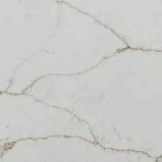 a white marble textured surface with cracks and cracks in the top right hand corner