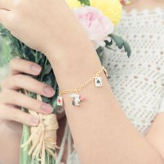 Unlock the secret of timeless style with Secret Garden Rabbit Bracelet. Meticulously crafted with an elegant poker charm and subtly lustrous enamel, this exquisite adornment is the epitome of tasteful luxury. A heartfelt addition to any jewelry collection. DETAILS Plating: 18K Gold Materials: 18K Gold on Brass Size:  8.03 "/20.4cm Weight:  10.1g Hypoallergenic design Whimsical Gold Jewelry With Removable Charms, Elegant Vintage Charm For Gift, Whimsical Jewelry With Removable Charms For Gifts, Elegant Enamel Jewelry With Lobster Clasp, Enamel Dangling Charms For Gifts, Whimsical Jewelry With Vintage Charm As A Gift, Whimsical Vintage Charm Jewelry As A Gift, Enamel Jewelry As A Gift For Her, Enamel Jewelry As Gift For Her