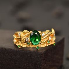 a green ring sitting on top of a wooden block