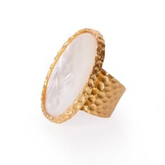 The Statement ring lives up to its name with a stunning large oval stone set in an 18K gold plate over hypoallergenic and nickel-free brass. You won't need to wear any other ring, but the more the merrier, so pair it with some of our dainty rings on the other hand. This ring is perfect for vamping up any look. Details: METAL 18k Gold Plated Over Brass MATERIAL Mother of Pearl SIZE 1.25 in x 1.5 in Please note: Due to the one-of-a-kind nature of the medium, exact colors and patterns may vary slig Elegant Hammered Rings, Luxury Gold Oval Cabochon Dome Ring, Timeless Gold Dome Ring With Cabochon, Luxury Gold Dome Ring With Oval Cabochon, Formal Oval Hammered Jewelry, Elegant Gold Opal Cabochon Ring, Elegant Gold Crystal Ring With Polished Finish, Gold Oval Brass Rings, Elegant Brass Dome Ring