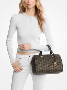 Our Grayson duffel is a glamorous finishing touch to any outfit. Covered in our metallic Empire monogram print, it’s topped with our charm and pyramid-stud accents for added shine. Top handles and an adjustable shoulder strap mean there are multiple ways to wear it. Michael Kors Collection, Monogram Prints, Metallic Logo, Signature Logo, Print Top, Pyramid, How To Take Photos, Logo Print, Satchel