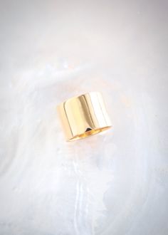 A statement gold wide band ring made from gold plated sterling silver. This gorgeous gold ring packs a punch. A modern staple for your collection.✦ DETAILS ✦✧ Name: Kahekili - (KAH heh KEE lee) - the thunder.✧ You will receive 1 ring 14mm wide. 9mm Band Sold Separately.✧ Available in whole sizes 5-11. PLEASE ORDER ONE SIZE UP; Wide rings fit tighter.✧ Gold Vermeil - gold plated sterling silver.✧ All Ke Aloha Jewelry pieces come packaged thoughtfully, beautifully, and ready for gift giving. Photo Gold Cuff Ring, Thick Gold Ring, Flat Ring, Wide Band Ring, Gold Statement Ring, Wide Rings, Gold Band Ring, Wide Band Rings, Cz Ring