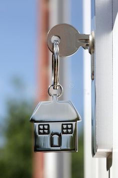 a house shaped keychain hanging from the side of a door