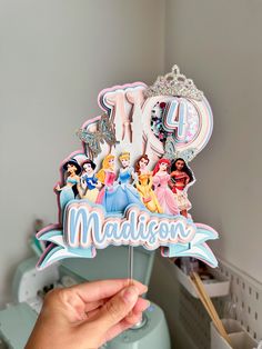 someone holding up a cake topper with the number fortyth birthday decorations on it