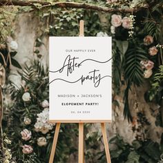 an easel with a sign that says after party on it in front of flowers