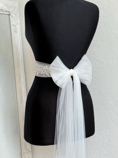 A stunning, elegant statement wedding sash is exquisitely beaded in beautiful vintage pattern. Your choice tulle  sash is attached to the beading and ties at the back into a bow.  An ultimate luxurious accent piece for your wedding dress or for any special occasion dresses. Accentuate your waist and add a touch of feminine charm to any dress with this tulle sash. Even the most simple gown can transform into a dreamy ensemble with this voluminous bow. Color embroidery - ivory or white Color tulle may be different  - white, ivory... and other Bead embroidery length 50 cm The belt is made as a long ribbon that you can tie around your waist. Elegant Tulle Bridal Accessories, Elegant Tulle Bridal Accessories For Bridal Shower, Elegant Tulle Veil For Bridal Shower, Elegant White Tulle Fabric For Ceremony, Elegant Bridal Belt With Satin Bow For Wedding, Elegant Tulle Bridal Accessories For Bride, Elegant Bridal Accessories In Tulle, Elegant Organza Bridal Accessories For Ceremony, Elegant White Bridal Belt With Satin Bow