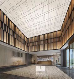 an empty lobby with wood paneling on the ceiling