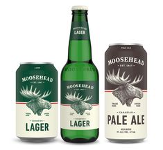 three bottles of moosehead pale ale, one with an eagle head on the front and one with a deer's head on the back