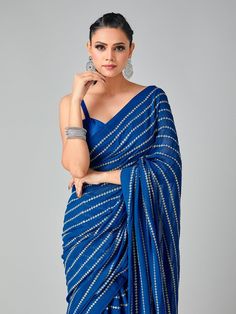 Royal blue sari with gold sequin horizontal stripes in soft georgette fabric. The blouse is a matching blue art raw silk fabric. This saree can be made in ANY color. If you want it in a different color, please send us a convo.  Sari Length: 5.5m Blouse Fabric: 1m   MEAUREMENTS & CUSTOMIZATIONS   If you want the blouse stitched, please choose the 'Stitched' option from the 'Blouse' drop-down menu.  This blouse can be purchased in your standard sizing and pattern. Please choose your 'Chest Size' (measured in Inches) from the drop-down box. All our blouses come with in-built padding and hooks at the back for closure.    For custom sizing and pattern, please include the below measurements in the the notes whenever you placed the order.  * Chest size: * Waist size: * Blouse Length: * Bicep: * A Blue Party Saree, Royal Blue Sari, Saree Black And White, Graduation Saree, Black And White Saree, Royal Blue Saree, Blue Sari, Gold Saree, Party Saree