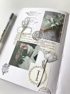 an open book with pictures and flowers on it, next to a pen that is laying on top of the page