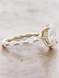 a close up of a diamond ring on a table