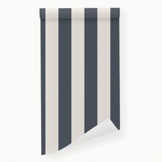 a black and white striped wallpaper with a corner cut in half to show the vertical stripes