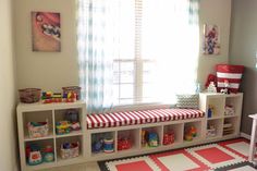 a child's playroom with toys and bookshelves in the corner,