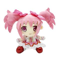 a stuffed animal doll with pink hair and big eyes sitting on top of a white surface