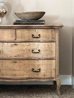 an old wooden dresser with a bowl on top