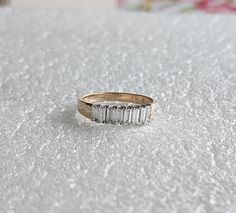 a diamond ring sitting on top of a white table