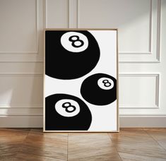 a black and white poster with three billiards on it in front of a wall