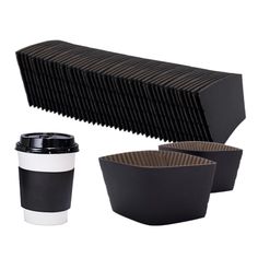 coffee cups and trays sitting next to each other on a white surface with black stripes