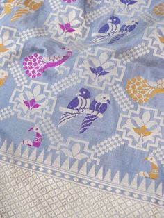 a blue and white table cloth with birds on it