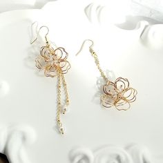 👂PRODUCT DETAILS Asymmetric Wire Floral Earrings by ELEVEN11DREAM - Material: High Quality Crystal & 14k gold plated + Swarovski Pearl - Size: Length 3.93in. & 2.75in. /Drop Length 3.34 in. & 2.16in. /width1.18 in.     Length 9cm & 7cm /Drop Length 7.5cm & 5.5cm/width3cm - Sold in pairs 🎈SHIPPING - All orders will be shipped within 1-3 business days after the order has been received - Ship all orders via USPS First-Class Mail - FREE SHIPPING for all USA domestic orders 💖PLEASE READ THE PRODUCT DESCRIPTION - All products are made by my hand with love and care in my studio - All products are nicely packaged in a protected clear box or bag to avoid damage - Keep your jewelry away from water or any liquid chemicals to avoid discoloration (for example, swimming or bathing) - Safely store you Spring 3d Flowers Dangle Earrings, Elegant Spring Flower Dangle Earrings, Delicate Flower Shaped Earrings For Spring, Delicate Flower-shaped Earrings For Spring, Gold Earrings With 3d Flowers For Spring, Spring Flower Dangle Earrings, Single Metal Flower Earring, Delicate Dangle Earrings For Spring, Gold Feminine Flower Earrings With 3d Flowers