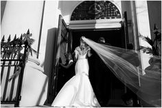 the bride is getting ready to walk down the aisle with her veil blowing in the wind