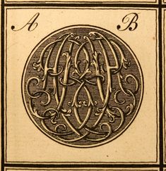 an image of a letter in a circle with swirls and scrolls on it's sides