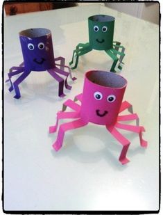 three paper cups with faces made to look like octopuses