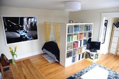 a living room filled with furniture and bookshelves