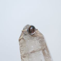 Sometimes you want to gaze down at your ring and see perfect balance and grace. That's what this Dainty Smoky Quartz Delica Ring has to offer. High-grade smoky quartz stone with a simple, sterling silver design. Perfect little ring. Lovely, traditional, dainty ring of 10X12 mm Smoky quartz cabochon set in .925 sterling silver oxidized and burnished bezel and wire. Simple, elegant and perfect. This lovely, translucent, and sparkling warm, taupe grey-colored ring is created using traditional silve Spiritual Nickel-free Rings For Everyday, Heirloom Sterling Silver Stackable Jewelry, Spiritual Sterling Silver Stackable Promise Rings, Spiritual Oval Stackable Moonstone Ring, Spiritual Sterling Silver Opal Ring, Spiritual Oval Moonstone Stackable Ring, Heirloom Sterling Silver Promise Ring Jewelry, Heirloom Oval Stackable Jewelry, Nickel Free Fine Jewelry Promise Ring