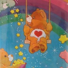 two teddy bears sitting on a swing with stars and rainbows in the sky behind them