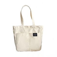 Introducing our Women's Canvas Tote Bag, a perfect blend of style and practicality for the modern woman. Crafted with high-quality cotton, this designer handbag is a versatile accessory that effortlessly transitions from casual outings to beachside adventures. With its solid color design, this tote bag exudes understated elegance. The spacious interior offers a large capacity, allowing you to carry all your essentials and more. Its durable construction ensures it can withstand the demands of eve Double Handle Canvas Bag With Pockets For Shopping, Casual Tote Bag With Zipper Pocket, Canvas Satchel With Pockets For Shopping, Shopping Canvas Satchel With Pockets, Trendy Canvas Bag With Zipper Pocket And Double Handle, Trendy Canvas Hobo Bag In Tote Shape, Trendy Canvas Hobo Tote Bag, Casual Canvas Softback Shoulder Bag, Daily Use Canvas Shoulder Bag With Zipper