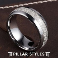 a wedding ring is shown on top of a piece of brown leather with the words pillar styles