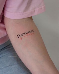 a woman's arm with the word happiness tattooed on it