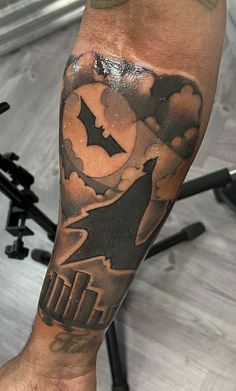 a man with a bat tattoo on his leg