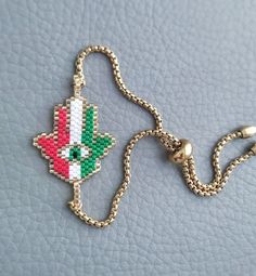 This is an Elegant beaded bracelet featuring Hamsa Palm, it's braided by hand in Italian flag colors and attached to an adjustable stainless steel chain.  This beautiful bracelet makes a beautiful and thoughtful Malocchio protection jewelry and a perfect gift for your loved ones.  Metal parts are made of high quality stainless steel, it's hypoallergenic and durable  All our items are custom made, it takes 3-5 days to get your order prepared.  The delivery date will depend on your location.  * USA - 2 - 4 weeks * Canada - 2 - 5 weeks * Europe - 2-3 weeks * Other - 2 - 4 weeks Please read our frequently asked questions FAQ to find out more Adjustable Multicolor Chain Bracelet, Hand-strung Adjustable Chain Bracelet For Gift, Adjustable Hand-strung Chain Bracelet As Gift, Handmade Adjustable Multicolor Chain Bracelet, Adjustable Handmade Multicolor Chain Bracelet, Adjustable Multicolor Handmade Chain Bracelet, Adjustable Jubilee Chain Bracelet For Friendship, Handmade Adjustable Chain Bracelet With Round Beads, Hand-strung Chain Bracelet With Round Beads As Gift