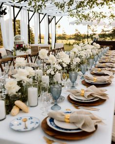 a long table set with plates and place settings