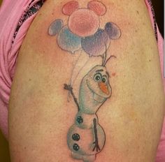 a woman's stomach with a tattoo of a snowman holding balloons