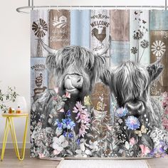 two shaggy haired cows are standing in front of a floral shower curtain with the words new england printed on it