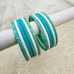 This children’s bangle set is specially curated with teal blue and ivory white. South asian bracelets come in a variety of styles, colors, and finishes. We at Banglez take creating a personalized bangle set to another level! You could say helping you find your favorite stack of bangles as one of our greatest missions. We hope you love them as much as we do! Handmade White Bangle For Festive Occasions, White Handmade Bangle For Festive Occasions, White Stackable Bangle, Adjustable White Bangle For Festive Occasions, Handmade White Bangle As Gift, Festive Turquoise Bangle Bracelets, White Bangle Bracelets For Festive Occasions, Adjustable Blue Stackable Bangle, Festive Turquoise Bangle Bracelet