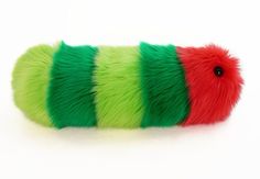 a green and red stuffed animal caterpillar on a white background with clippings