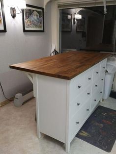 a kitchen island with drawers in the middle