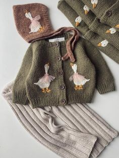 two knitted sweaters, one with ducks and the other with geese