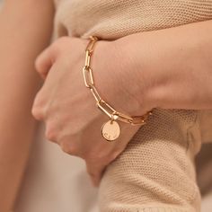 Forever linked by love. Featuring an iconic hinge to clip on your hand-engraved charms, this personalized link bracelet can be hand-engraved with your special words or messages.Available in 18K Champagne Gold PlatedCharm: 0.6 Diameter, 0.03 ThicknessChain length &amp; style: 7.3 Thick Trace ChainCharms are removable from this chain and can be worn with other Merci Maman charmsHand-engraved in our Paris workshopSent with love in a complimentary gift boxAny slight variations in lettering depth Luxury Adjustable Bracelet With Logo Charm, Everyday Yellow Gold Charms, Modern Charms Bracelets, Everyday Name Bracelet With Charms, Engraved Classic Charm Bracelet, Classic Everyday Charm Bracelet, Everyday Classic Charm Bracelet, Minimalist Chain Bracelet With Charms As Gift, Classic Engraved Charm Bracelet For Everyday