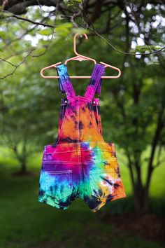 | Tie Dye Girl's Overall Shorts | ❤️ These vibrant little overalls are perfect for sunshiney spring and summer days! The material is incredibly soft, stretchy and durable for all the activities your little hippie will be doing. These overalls come in several different fabulous colors, but can also be ordered in custom colors, if you would like to design your own. Please check out our adult overall shorts in the link below to order a matching mommy & me set: https://www.etsy.com/listing/69416 Cotton Summer Overalls For Festivals, Cotton Overalls For Summer Festivals, Summer Festival Cotton Overalls, Playful Summer Shortalls, Multicolor Cotton Overalls For Summer, Multicolor Bottoms For Playtime In Summer, Multicolor Bottoms For Summer Playtime, Multicolor Summer Bottoms For Playtime, Multicolor Jumpsuits And Rompers For Spring Playtime