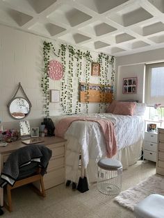 a bedroom with a bed, desk and mirror