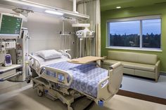 a hospital room with a bed and couch